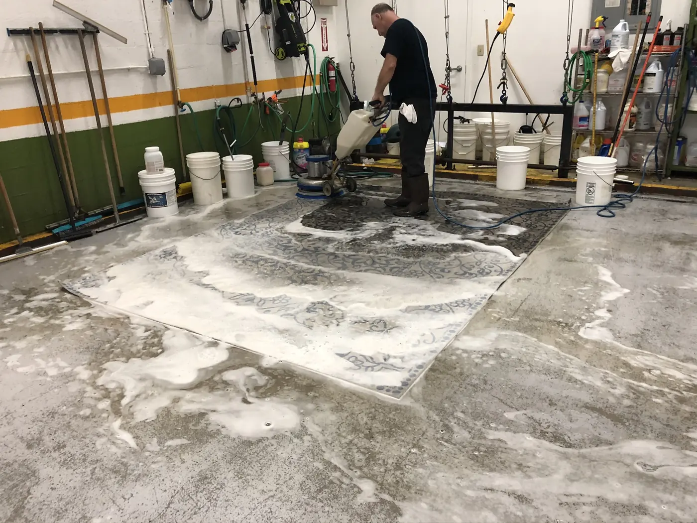 Large rug under suds on the wash floor